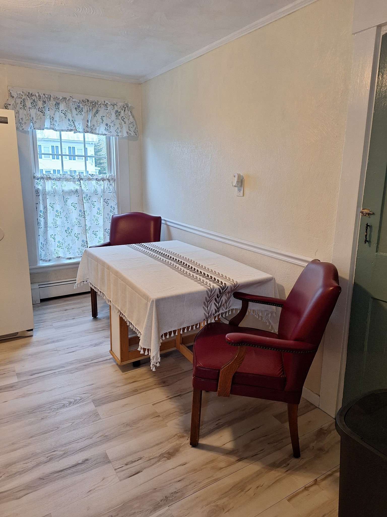 Dining area with table and comfortable chairs in Skowhegan contractor rental - perfect for meals